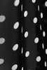 Polka dots are chic and can be worn any time of the year. The blouse is cut in a slightly loose fit from black silk with white polka-dots. 
