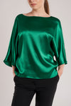 Part of a two piece silk suit, this emerald green top is tailored from a silk satin that ensures smoothness and comfort. 
