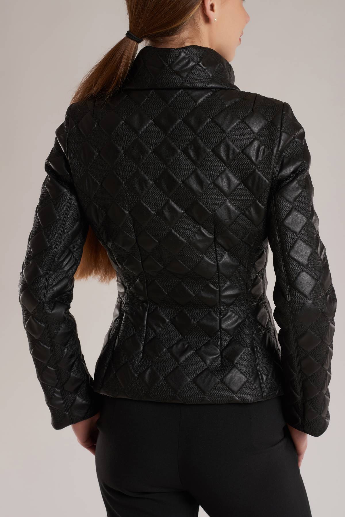 The jacket is tailored from black artificial leather. It follows the curve of your waist before cropping neatly at the hips. 