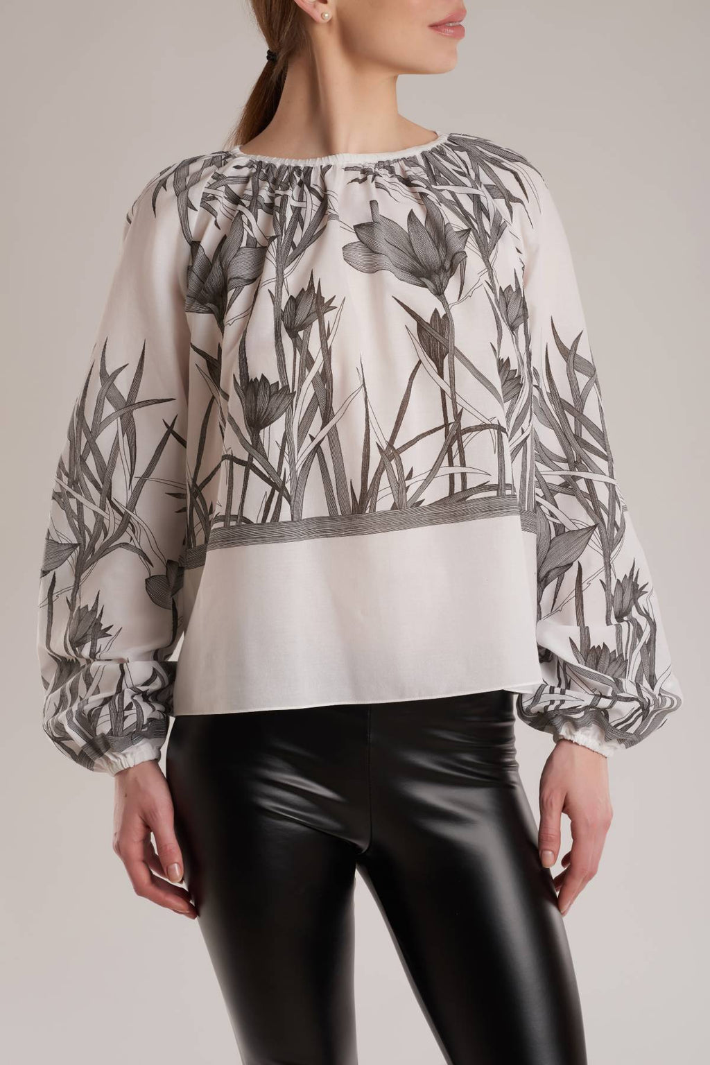 Cut for a loose fit, this top is made from soft white cotton decorated with black graphic floral print. 