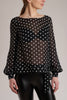 GINTA's blouse is cut in a loose fit from black fluid silk with white polka-dots.