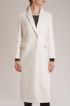 GINTA's high-quality white cashmere coat with structured shoulders and clean lines is an investment piece. 