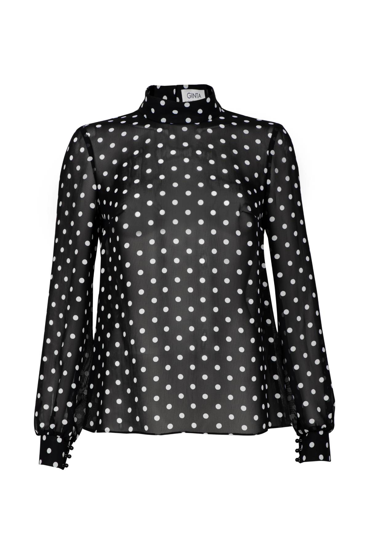 A black blouse with white polka-dots has a detachable pussy-bow tie. Wear the tie in a neat bow, as a belt or remove it for a more relaxed fit.