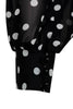 A blouse is cut in a slightly loose fit from black silk with white polka-dots and has blouson sleeves with buttoned cuffs.
