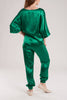 The emerald green silk satin suit is elasticated at the waist and ankles for a flexible fit.