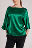 The loose silhouette of an emerald green silk satin top is a contemporary take on the wardrobe classic.