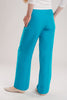 The breathable silk and linen blend pants in vibrant turquoise have a long silhouette that looks elegant paired with the flat shoes.