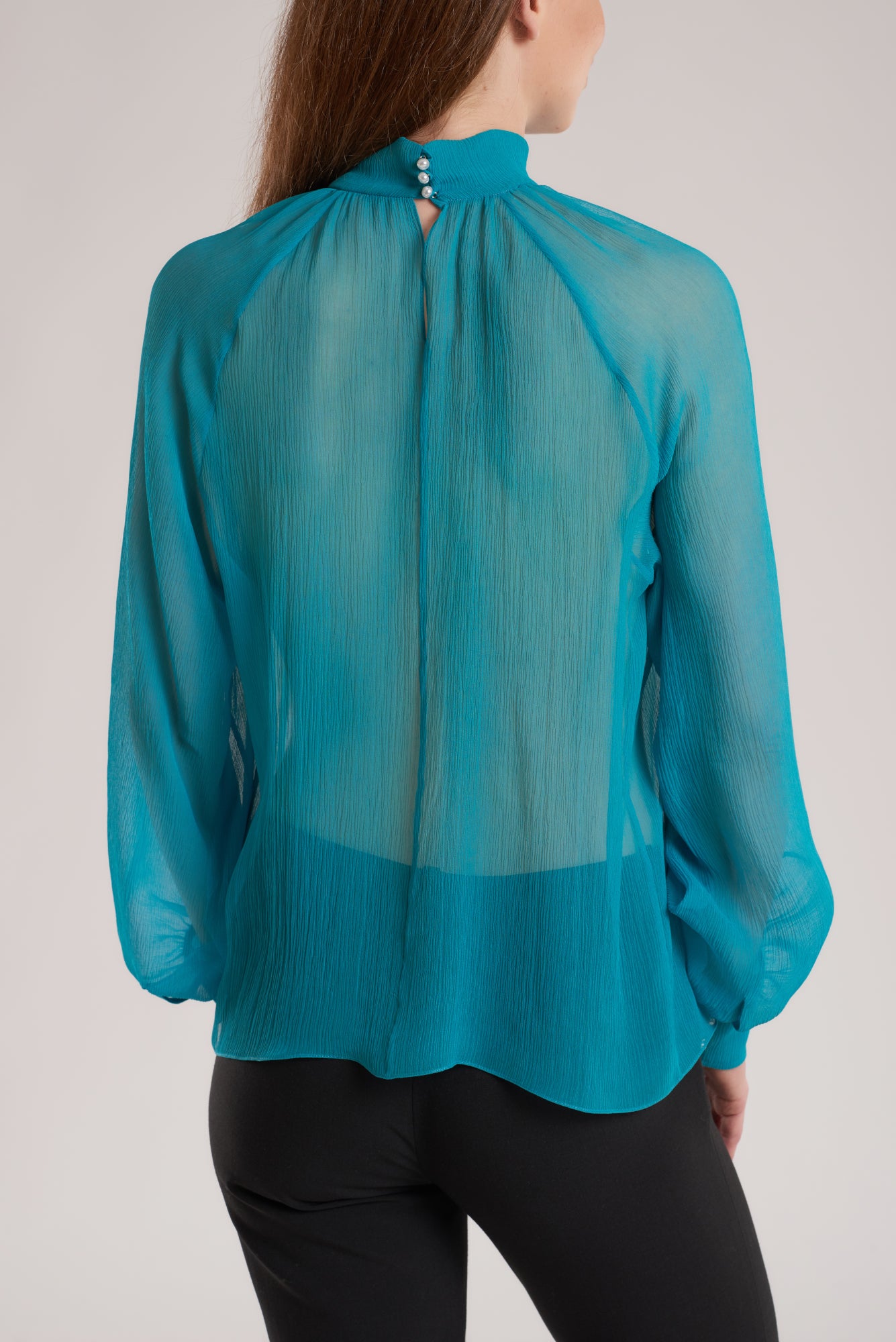 This blouse is cut from silk georgette and gathered at the collar. Wear it over a pair of trousers to show off the hem. 