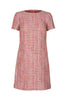 GINTA’s pink tweed dress has a rounded neckline and a figure-flattering shape.