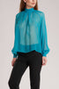 This turquoise blouse is cut from pure silk georgette and gently gathered at the collar. 